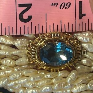 14k blue topaz clasp, rice pearls necklace.